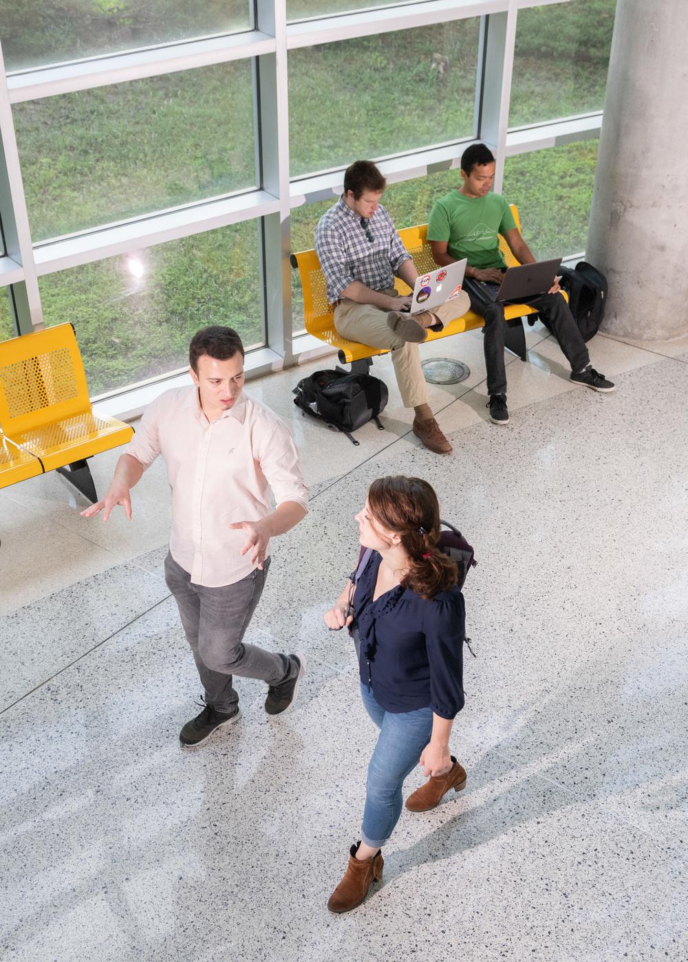 Two students walking down a hallway.